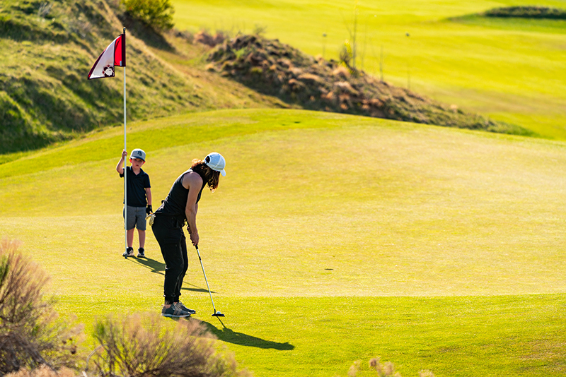 family playing golf